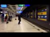 A man standing in front of a train station.