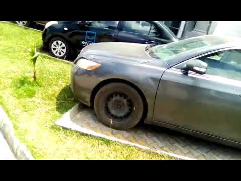A car that has been knocked over by another car.
