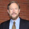 A man with a beard and mustache wearing a suit