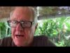 A man with glasses is talking to someone