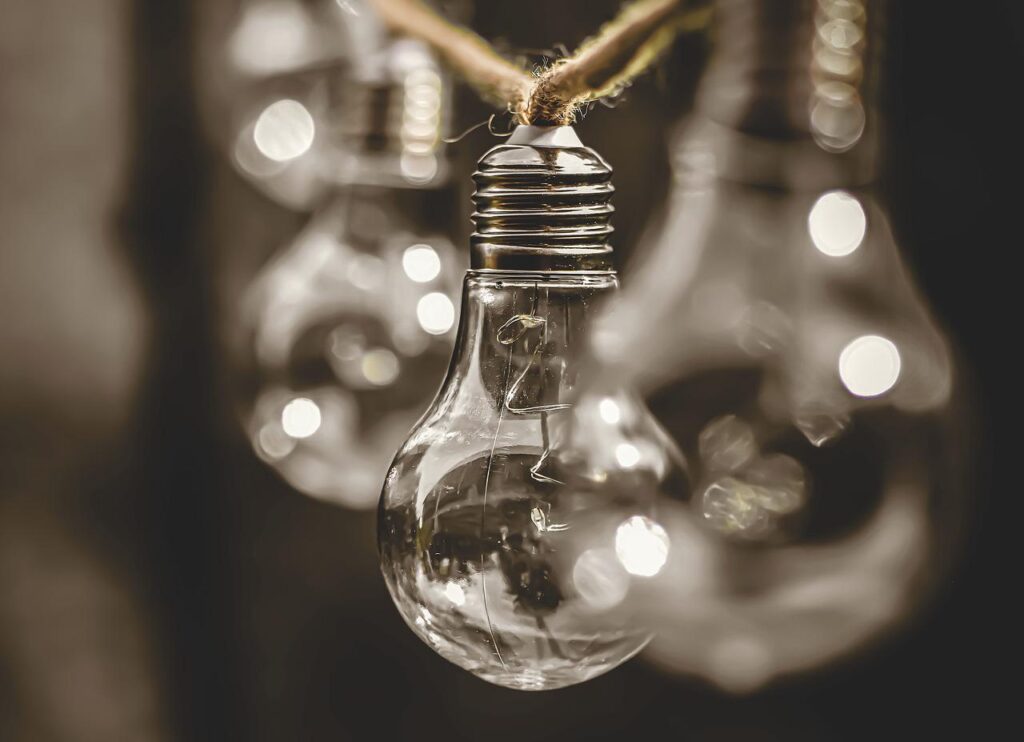 A close up of a light bulb hanging from a string